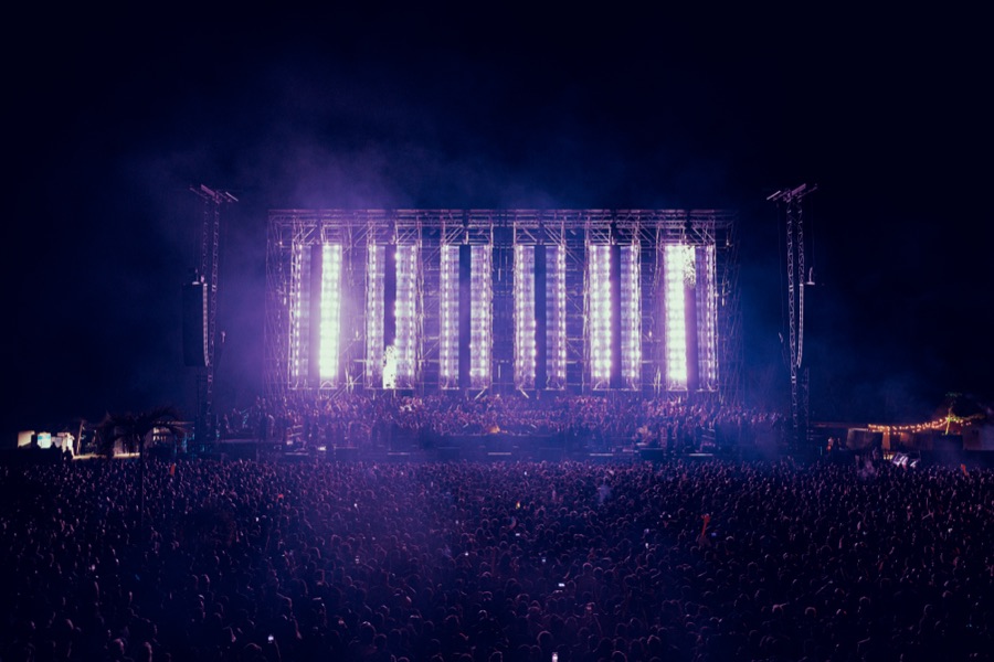Sunset festival atmosphere with silhouetted crowd